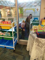 Kid in learning commons with mom