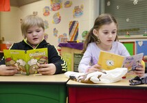 Two students reading their books in French class