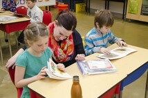 Teacher guiding student on reading french